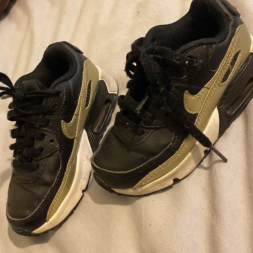 Nike Black and Gold Sneakers with Iconic Design